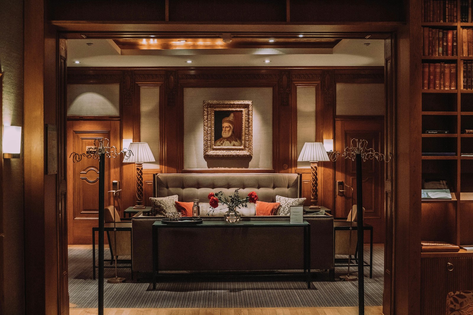 A panelled sitting corner off the room, lamplit.